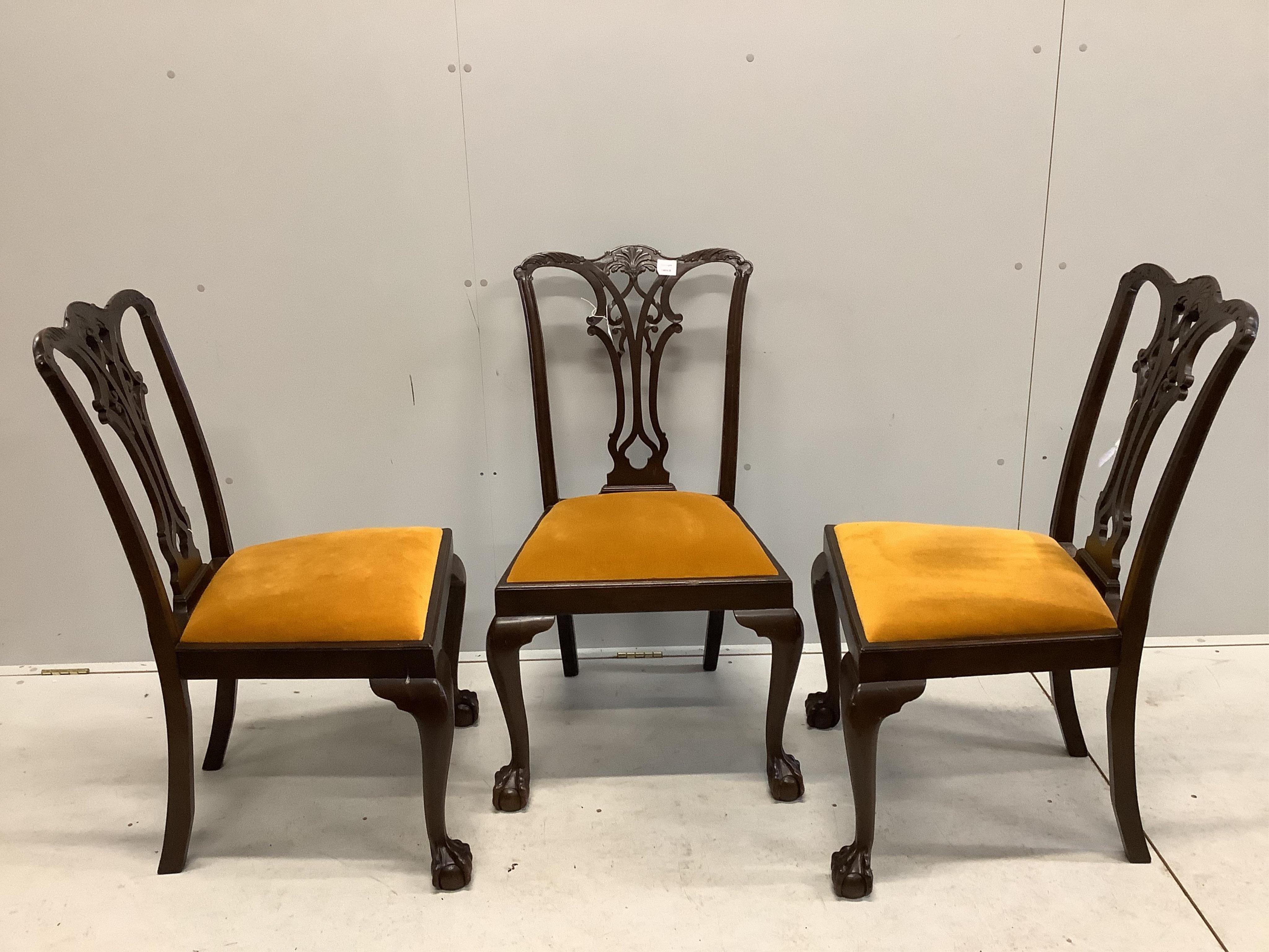 Four Chippendale style mahogany dining chairs, with pierced, interlaced splats above old gold velour drop in seats, one with arms. Condition - fair